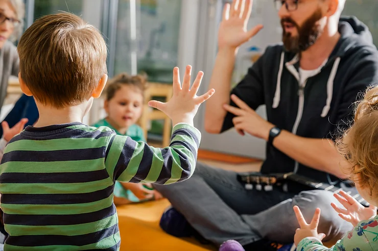 Male teacher teaching toddlers numbers