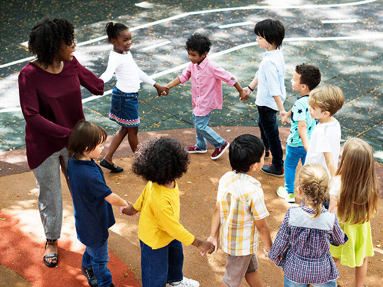 Teacher with students holding hands in a circle