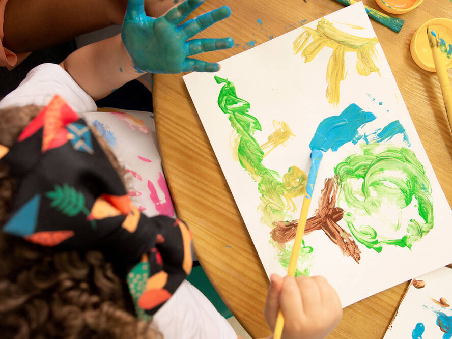 Toddler painting a picture