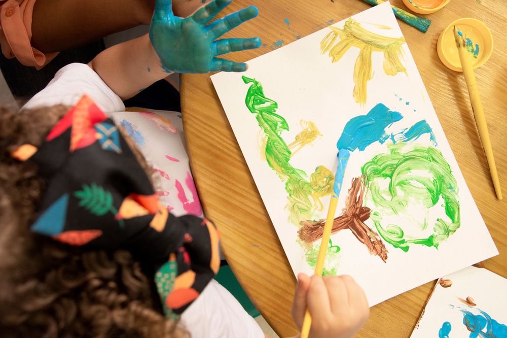 Toddler painting a picture