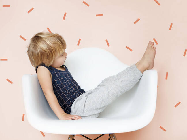 Young child playing on the chair header