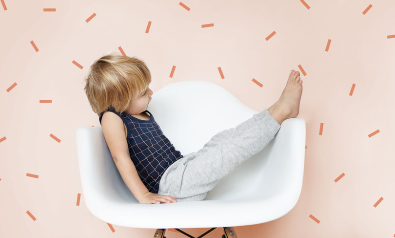 Young child playing on the chair header