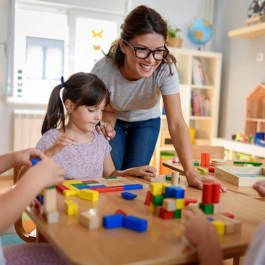 Adult and child playing with building blocks