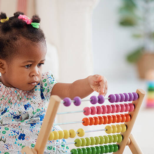 Baby girl playing with abacus