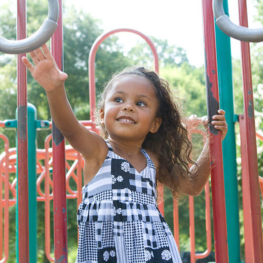 Girl grabbing the monkey bars