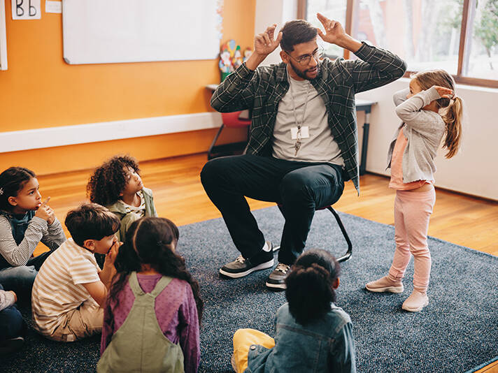 Male educator in a primary school class