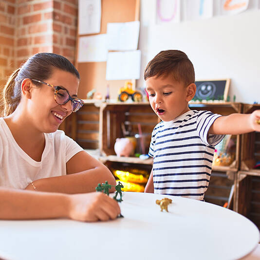 Mom sitting with young child doing homework