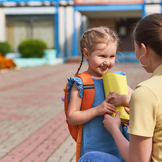 Mother dropping off daughter at school