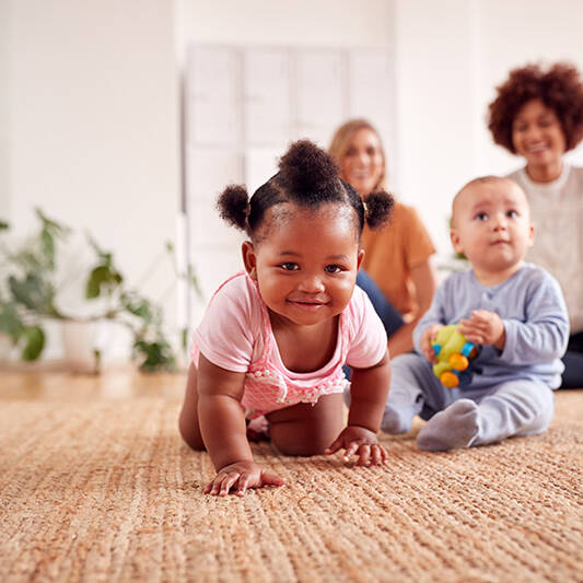 Two Mothers Meeting For Play Date With Babies At Home In Loft Apartment