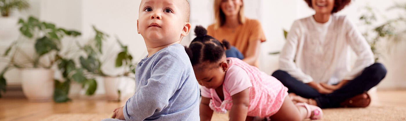 Two Mothers Meeting For Play Date With Babies At Home In Loft Ap