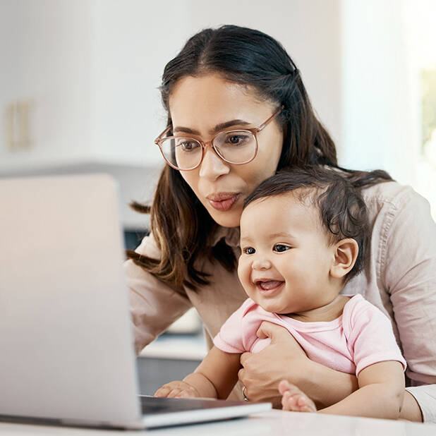 happy woman and baby with laptop