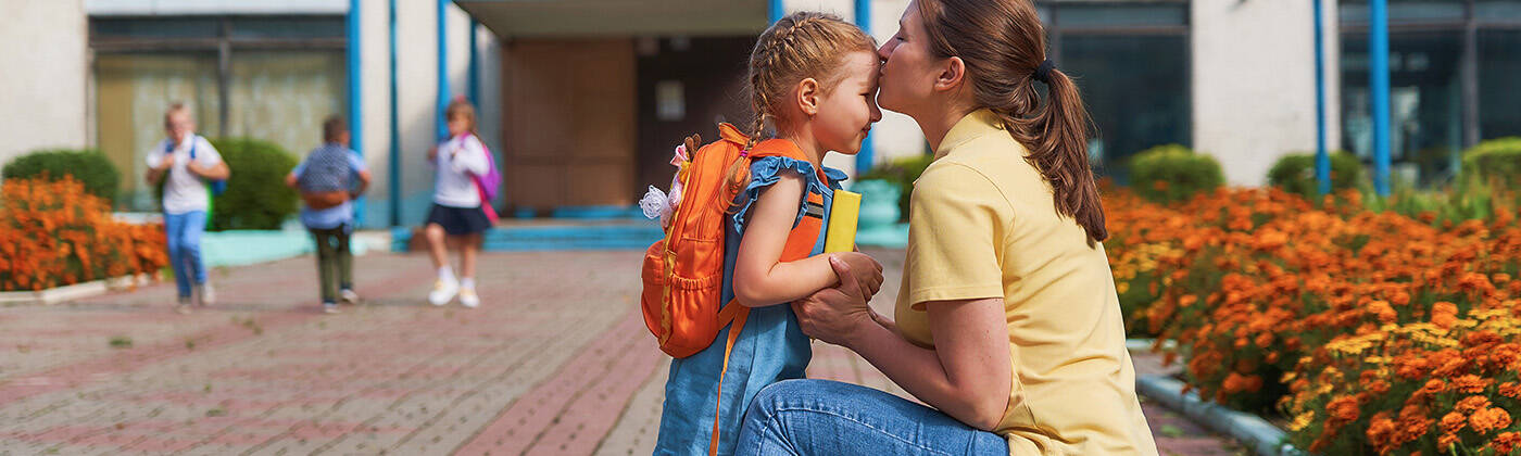 mother accompanies the child to school.