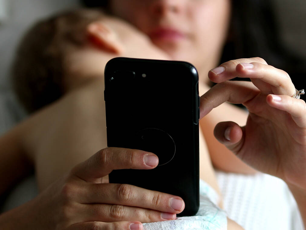 mother texting during childs nap