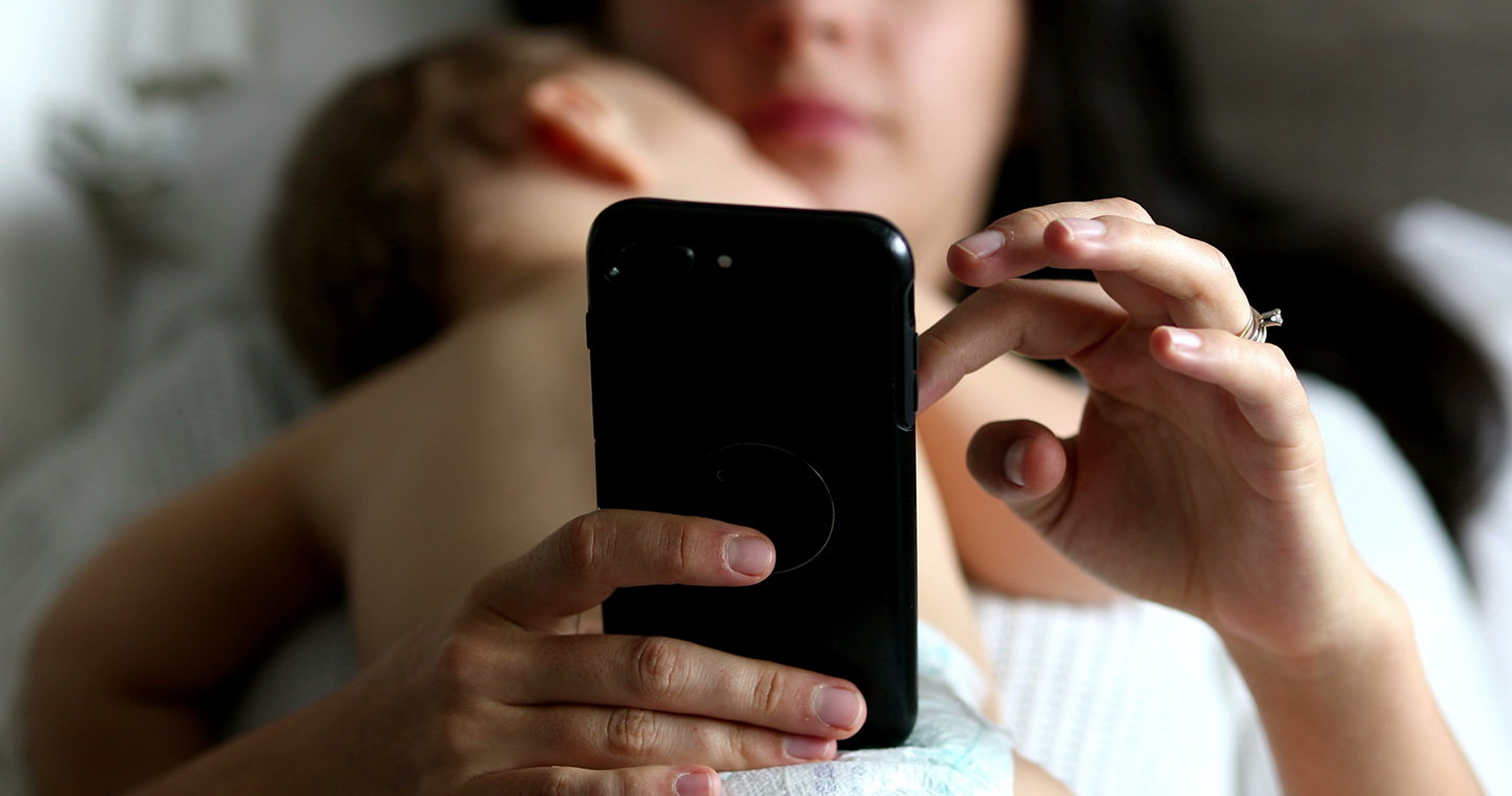 mother texting during childs nap